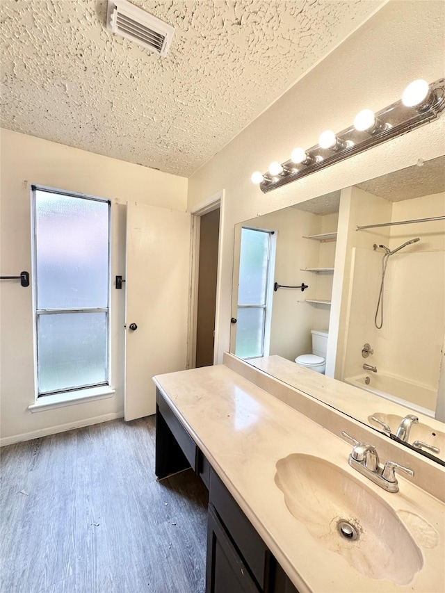 4230 E Terrace Creek Cir, Houston, TX 77014 - full bathroom with toilet, visible vents, shower / tub combination, vanity, and wood finished floors