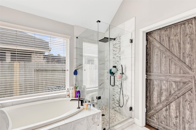 full bathroom featuring a stall shower, vaulted ceiling, and a bath