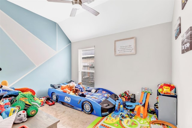 playroom with lofted ceiling, ceiling fan, and carpet floors
