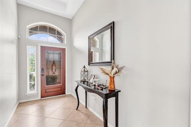entrance foyer featuring light tile patterned floors and baseboards