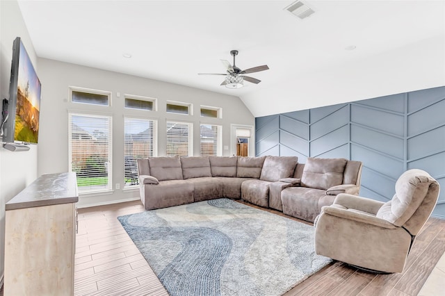 living room featuring ceiling fan, baseboards, visible vents, and wood finished floors