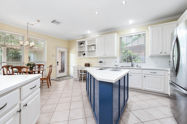 1910 Stormcroft Cir, Katy, TX 77450 - kitchen with a sink, crown molding, freestanding refrigerator, open shelves, and a chandelier