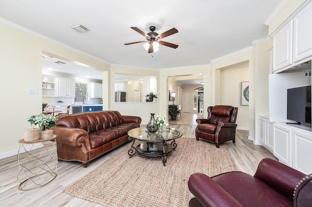 1910 Stormcroft Cir, Katy, TX 77450 - living room with light wood-style floors, ceiling fan, crown molding, and baseboards