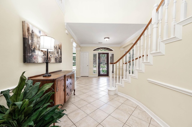 1910 Stormcroft Cir, Katy, TX 77450 - foyer entrance with light tile patterned floors, crown molding, baseboards, and stairway