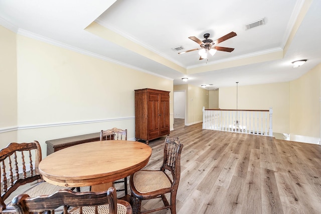 1910 Stormcroft Cir, Katy, TX 77450 - dining room featuring a raised ceiling, ceiling fan, light wood-type flooring, crown molding, and baseboards
