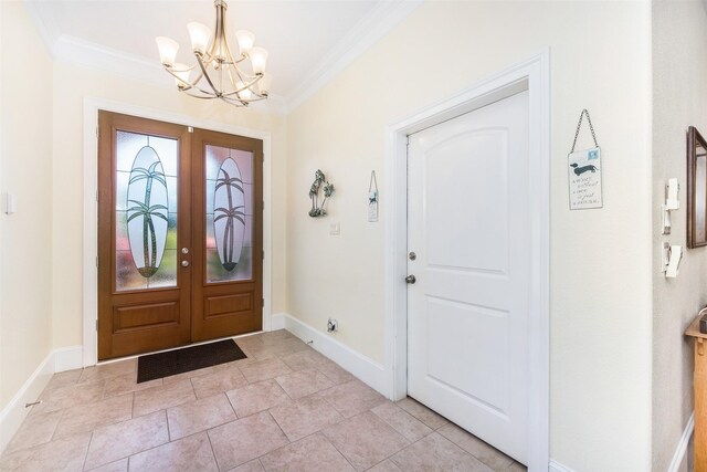 entrance foyer with baseboards, a notable chandelier, and crown molding