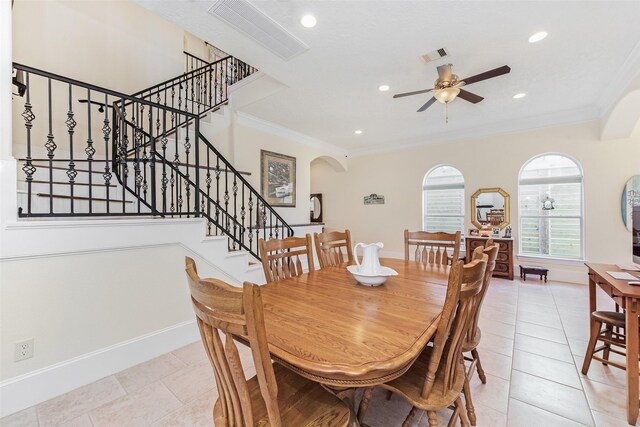dining space with a ceiling fan, stairs, visible vents, and crown molding