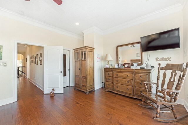 bedroom featuring baseboards, dark wood-style flooring, crown molding, and arched walkways