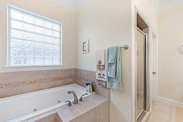 bathroom featuring tile patterned floors, crown molding, a whirlpool tub, and a stall shower