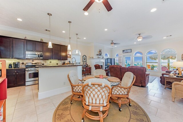 dining space with ornamental molding, light tile patterned flooring, a ceiling fan, and recessed lighting