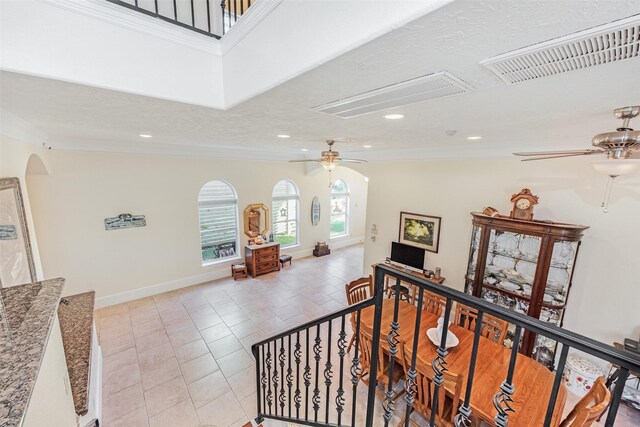 stairs featuring a ceiling fan, recessed lighting, attic access, visible vents, and crown molding