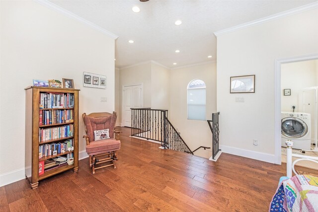 living area with washer / dryer, wood finished floors, ornamental molding, an upstairs landing, and recessed lighting