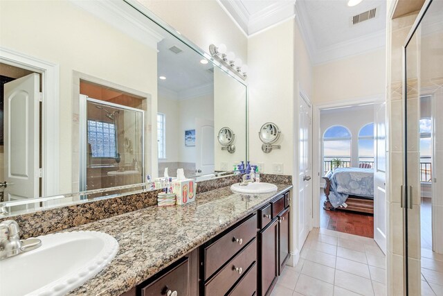 ensuite bathroom with a stall shower, tile patterned floors, visible vents, and a sink