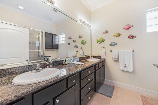 full bathroom with a stall shower, ornamental molding, double vanity, and a sink