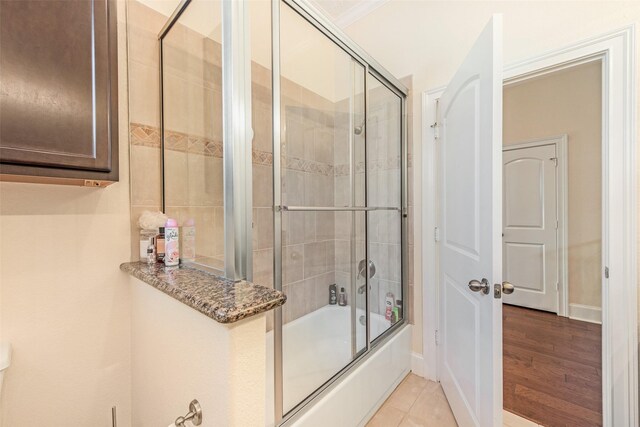 full bath featuring tile patterned floors and enclosed tub / shower combo
