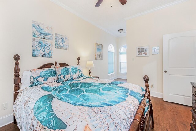 bedroom featuring ornamental molding, baseboards, a ceiling fan, and wood finished floors