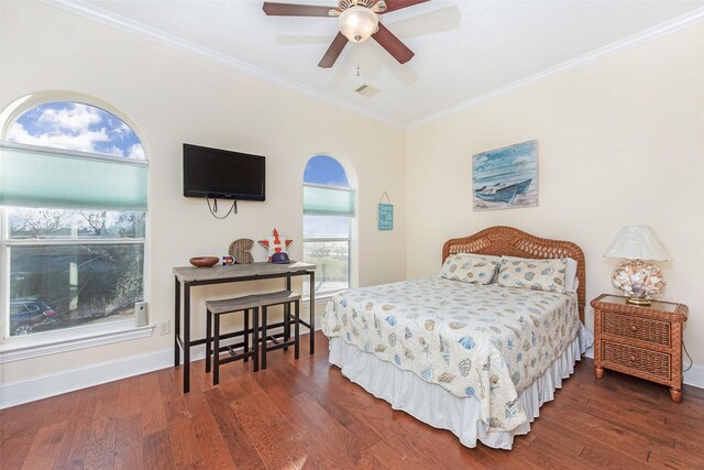 bedroom featuring visible vents, wood finished floors, baseboards, and ornamental molding