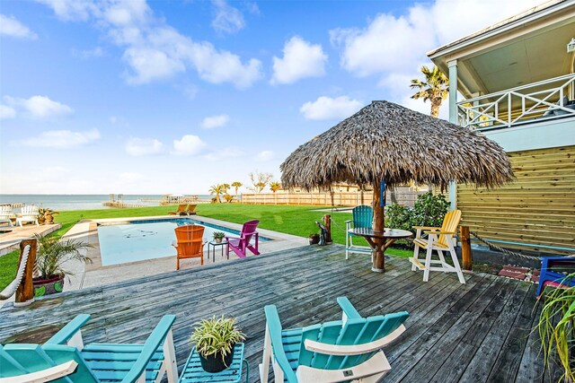 wooden terrace featuring a yard and a water view