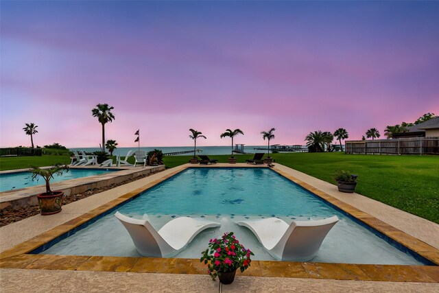 view of pool at dusk