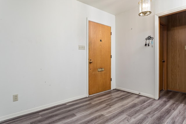 interior space featuring baseboards and wood finished floors
