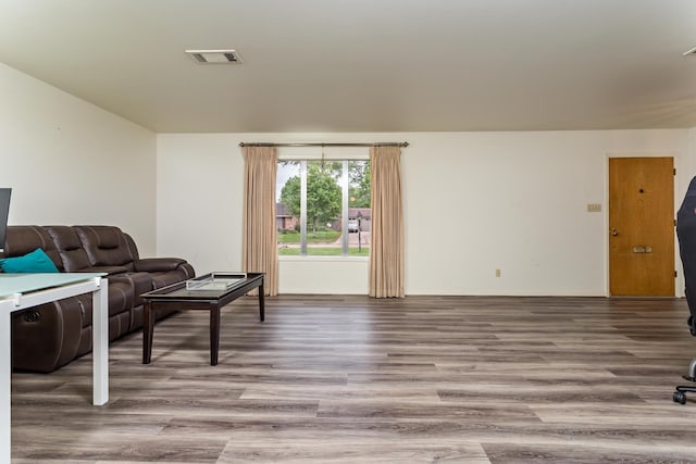 living room featuring visible vents and wood finished floors