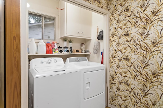 clothes washing area featuring cabinet space and washer and dryer