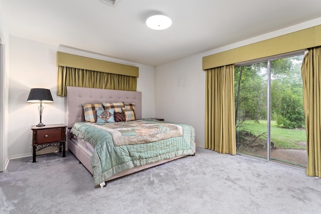 bedroom featuring baseboards, access to outside, and carpet