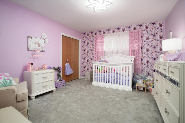 bedroom with a closet, wallpapered walls, and carpet