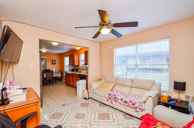 living room with light tile patterned floors and a ceiling fan