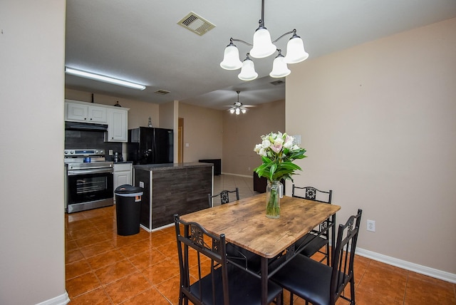 dining room with a chandelier, light tile patterned flooring, baseboards, and ceiling fan