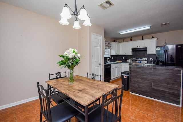 dining space with a chandelier, light tile patterned floors, and baseboards