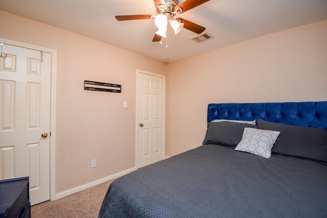 carpeted bedroom with baseboards and a ceiling fan