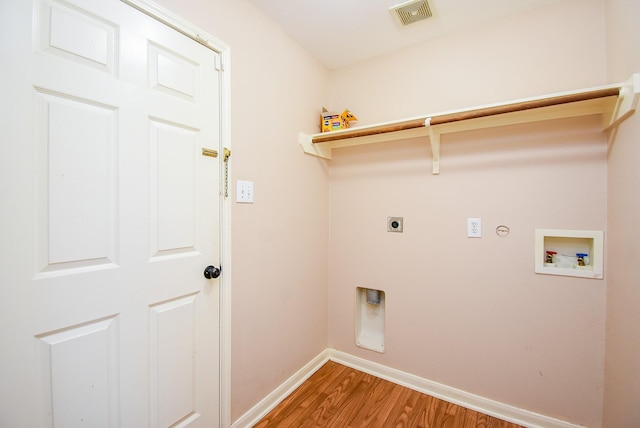 laundry area featuring electric dryer hookup, baseboards, light wood-style flooring, hookup for a washing machine, and gas dryer hookup