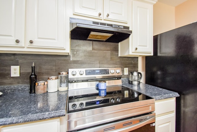 kitchen featuring stainless steel range with electric cooktop, under cabinet range hood, freestanding refrigerator, and white cabinetry