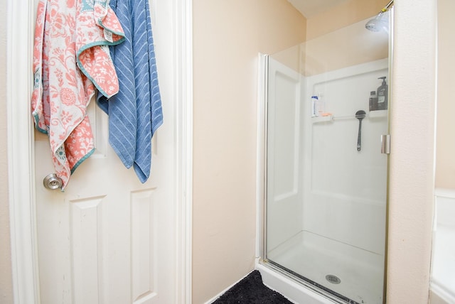 full bath with a shower stall