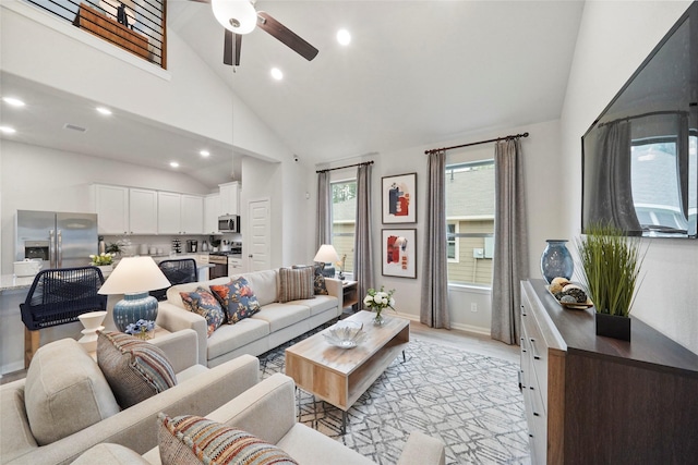 living room with a ceiling fan, light wood-style flooring, recessed lighting, visible vents, and high vaulted ceiling