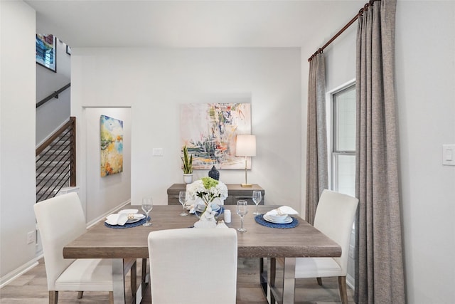 dining room with baseboards and wood finished floors