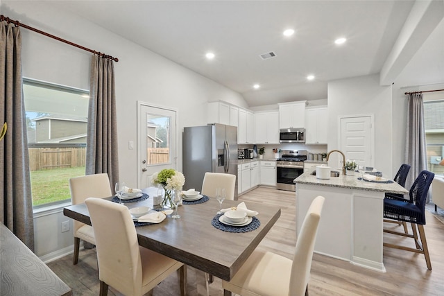 dining room featuring visible vents, recessed lighting, vaulted ceiling, light wood-style flooring, and baseboards