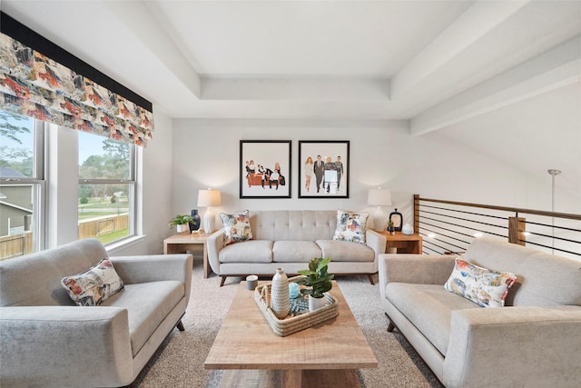 carpeted living room featuring beam ceiling