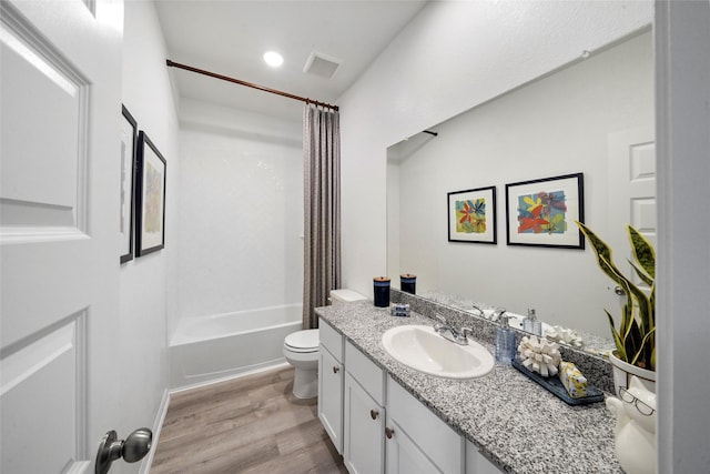 full bathroom with toilet, visible vents, shower / bath combination with curtain, vanity, and wood finished floors