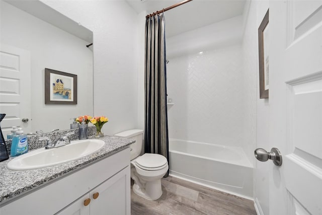 full bathroom featuring toilet, vanity, shower / bath combo with shower curtain, and wood finished floors