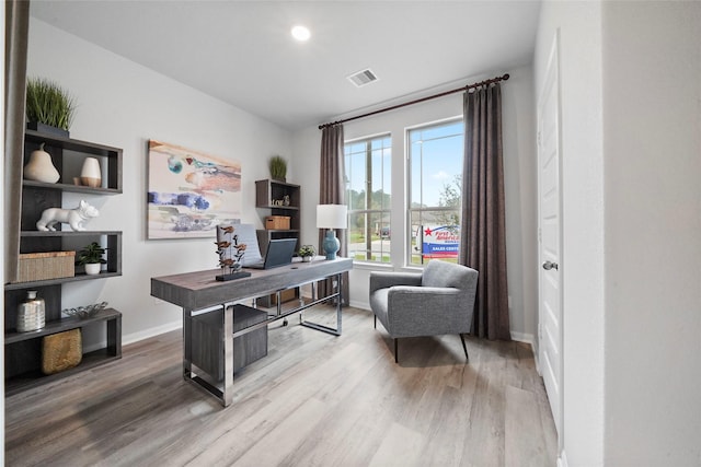 office with wood finished floors, visible vents, and baseboards