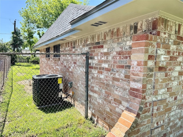 11615 Harrow St, Houston, TX 77093 - view of property exterior featuring a yard, brick siding, central AC unit, and fence