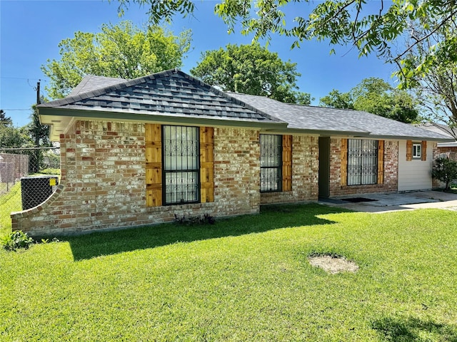 11615 Harrow St, Houston, TX 77093 - view of front facade with a front lawn, brick siding, a shingled roof, and fence