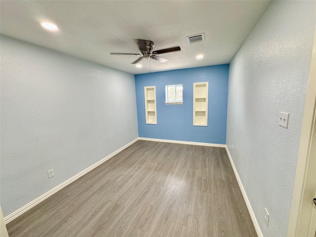 11615 Harrow St, Houston, TX 77093 - empty room featuring visible vents, wood finished floors, baseboards, and ceiling fan