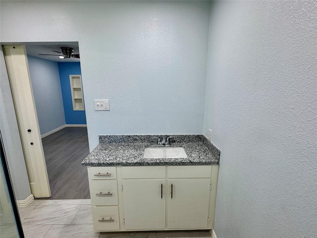 11615 Harrow St, Houston, TX 77093 - bathroom with baseboards, vanity, ceiling fan, and a textured wall