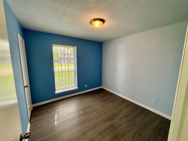 11615 Harrow St, Houston, TX 77093 - empty room featuring baseboards, dark wood-style flooring, and a textured ceiling
