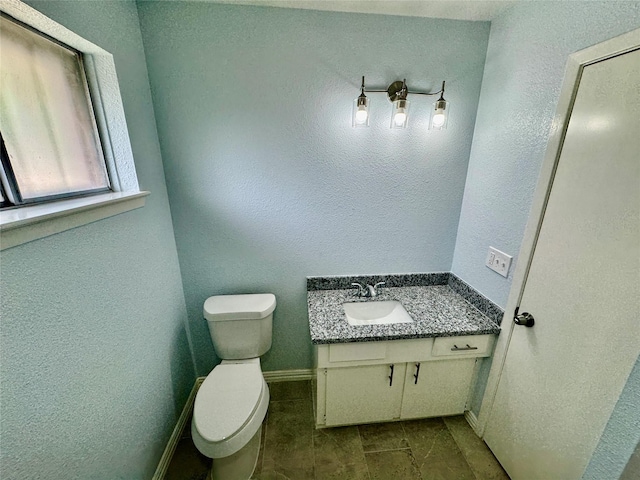 11615 Harrow St, Houston, TX 77093 - bathroom featuring toilet, baseboards, vanity, and a textured wall