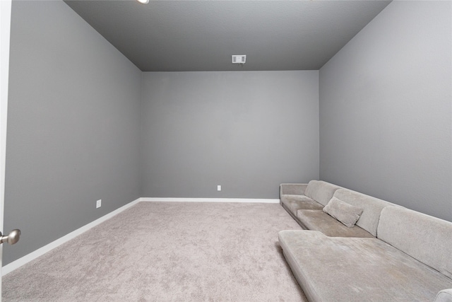 living area featuring carpet flooring and baseboards