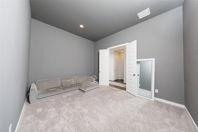 unfurnished bedroom with lofted ceiling, carpet flooring, baseboards, and visible vents